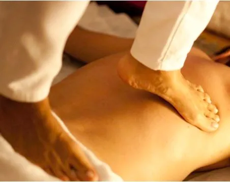 Ayurvedic Yoga Massage given with the feet on a client&rsquo;s back